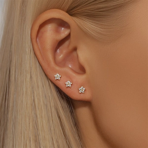 Close-up of S925 silver flower stud earrings with gold center and clear zircon crystals