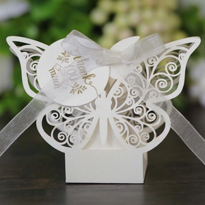 Detail of laser-cut butterfly gift box in white with silk ribbon and gold Thank You tag
