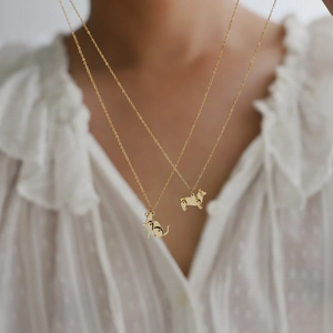 Gold-plated titanium steel necklaces with cute cat and corgi dog pendants on a model