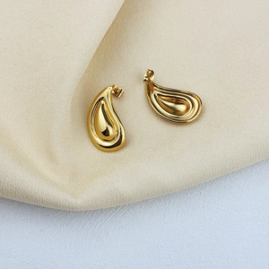 Classic 18K gold plated stainless steel teardrop earrings on minimalist fabric