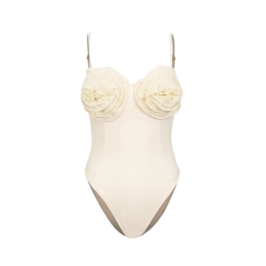 Detail of elegant 3D rose flower appliques on a cream one-piece swimsuit with thin straps