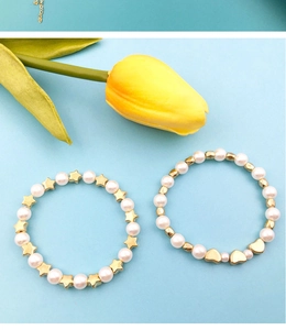Detail showing DIY bracelets with faux pearls and gold star heart shaped spacer beads