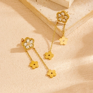 Gold flower tassel earrings with zircons and long chains on minimalist stone base