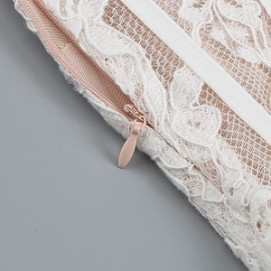Detail of delicate off-white lace fabric and matching pink invisible zipper closure