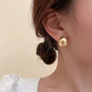 Elegant gold waterdrop stud earrings for women featuring a minimalist polished mirror finish