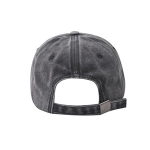 Close-up of adjustable metal buckle on vintage washed baseball cap with JC emblem