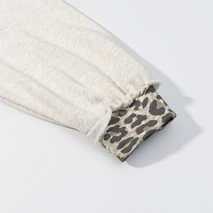 Detail shot of ribbed cuffs with leopard print splicing on a casual hoodie