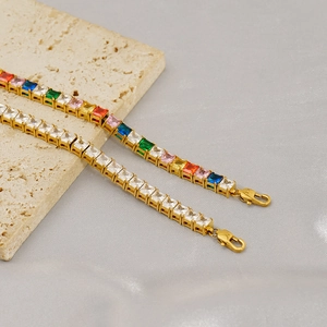 Detail of colorful and white zircon tennis bracelets with gold claw settings on stone