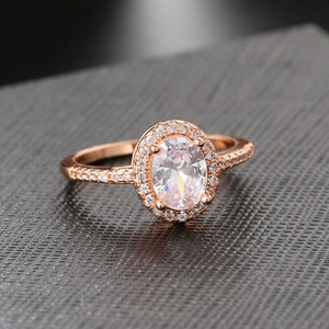 Classic rose gold engagement ring with large oval centerpiece and micro-pave crystals