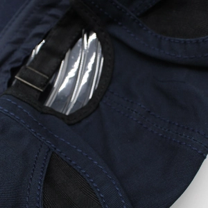 Close-up of navy blue beret showing adjustable strap with metal buckle and stitch detail