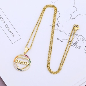Detailed close-up of a gold mom pendant necklace with rainbow zircon heart inlay