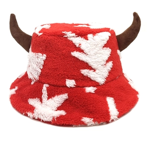 Close-up of plush funny Christmas hat with brown horns and white snowflake patterns