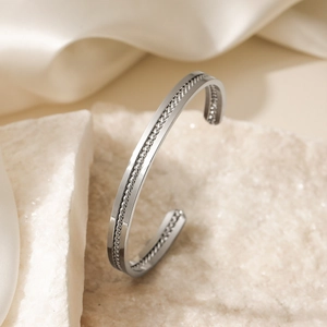 Minimalist silver stainless steel open bangle with intricate braided texture design