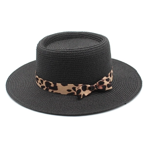 Detail of black woven boater hat featuring a stylish leopard print ribbon and bow knot