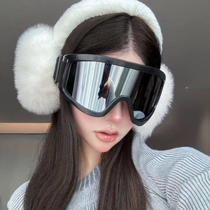 Outdoor skiing goggles with silver mirror lens and white plush earmuffs on model