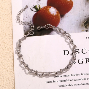 Detailed macro view of the silver horsebit chain with lobster clasp and adjustable link