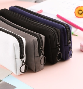 Detail view of canvas pencil cases in four colors with circular metal ring zipper pulls