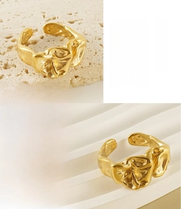 Detailed macro view of 18K gold plated irregular lava texture on stainless steel ring