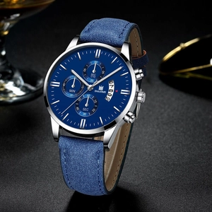 Blue leather strap watch with silver case and chronograph dial on black textured background