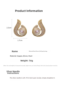 Detail view of mermaid tail earrings with pearls and cubic zirconia on white background