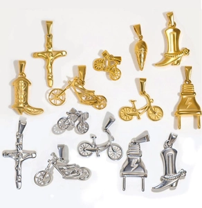 Close-up of gold and silver charms including crosses, boots, bikes and ice cream shapes