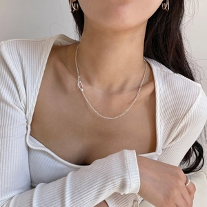 Minimalist 925 sterling silver interlocking bead necklace on model with white top