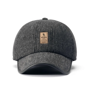 Close-up of dark grey textured winter cap featuring embossed leather patch and leather-edged brim