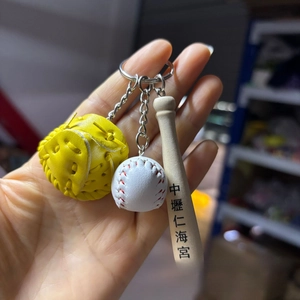Detail view of baseball keychain featuring a leather glove, mini ball, and wooden bat
