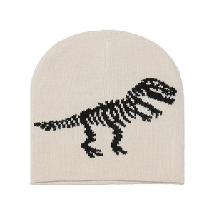 Detail view of cream knitted beanie showing clear black dinosaur skeleton jacquard pattern