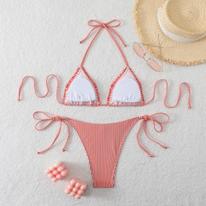 Detailed flat lay of red and white striped bikini set with high cut tie-side bottoms