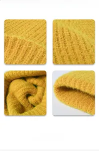 Close-up of ginger yellow knit fabric showing thick plush texture and ribbed pattern detail
