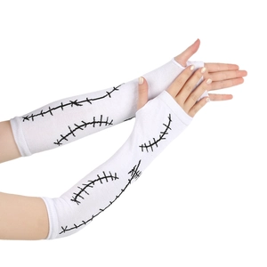 Detailed close-up of white knitted arm warmers with black Sally style stitching patterns