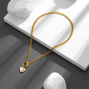 Minimalist gold OT buckle necklace featuring a white shell heart pendant on cubes