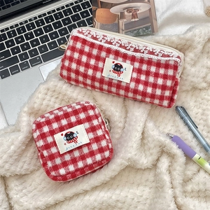 Detail of red and white plaid pouch set with lace trim and cute cartoon cat patch
