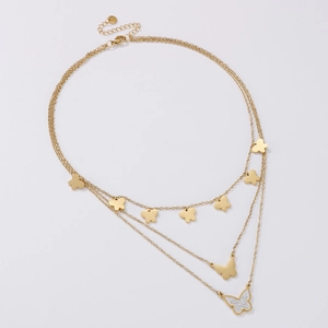 Detailed view of triple-layered gold butterfly pendant necklace with sparkly rhinestones