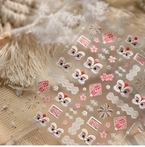 Macro detail of 5D embossed pink lion dance nail art stickers with cherry blossom patterns