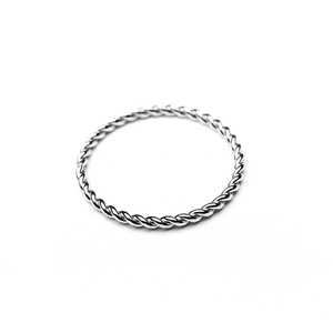 Detailed view of a silver twisted rope ring featuring intricate metal weave patterns