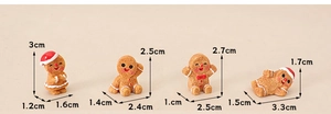 Detailed size view of four miniature gingerbread man figures for dollhouse decor