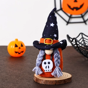 Close-up of orange Halloween gnome with black wizard hat and skull pendant on wood base