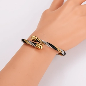 Three-tone twisted cable open bangle in gold, silver, and black stainless steel