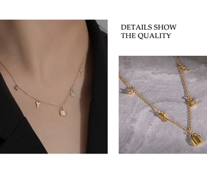 Close-up of a 925 sterling silver gold necklace featuring delicate lock and key pendants