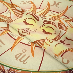 Macro shot of bohemian astrology tapestry fabric featuring Libra and Pisces zodiac patterns