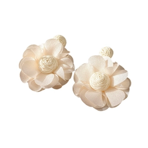 Elegant off-white fabric flower stud earrings with silk texture and woven center