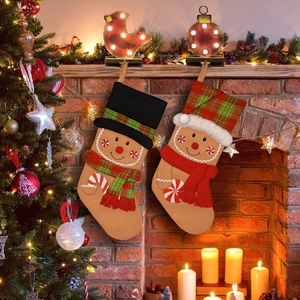 Gingerbread man Christmas stockings set with plaid hats on festive fireplace background