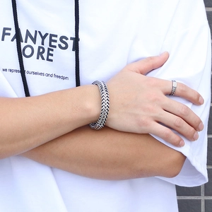 Close-up of double-row stainless steel keel bracelet and minimalist ring on male wrist