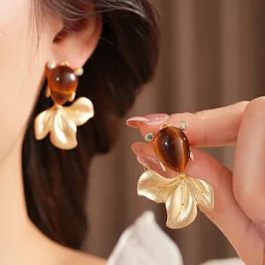 Vintage goldfish stud earrings with brown teardrop cat eye stones and matte gold finish