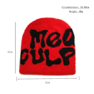 Red fuzzy knit beanie with black MEA CULPA graffiti text in a stylish streetwear design