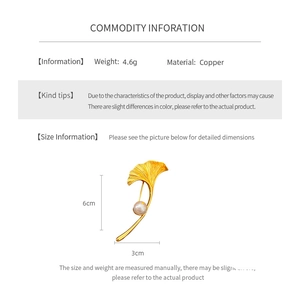 Detailed view of gold plated ginkgo leaf brooch with white pearl and 6cm x 3cm size guide