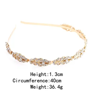 Elegant gold leaf headband for women with sparkling white rhinestones on white backdrop