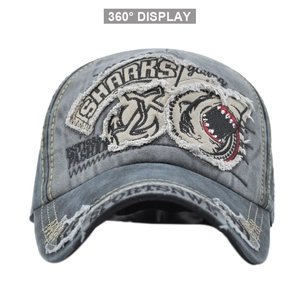 Close-up of shark embroidery and vintage washed texture on a grey baseball cap